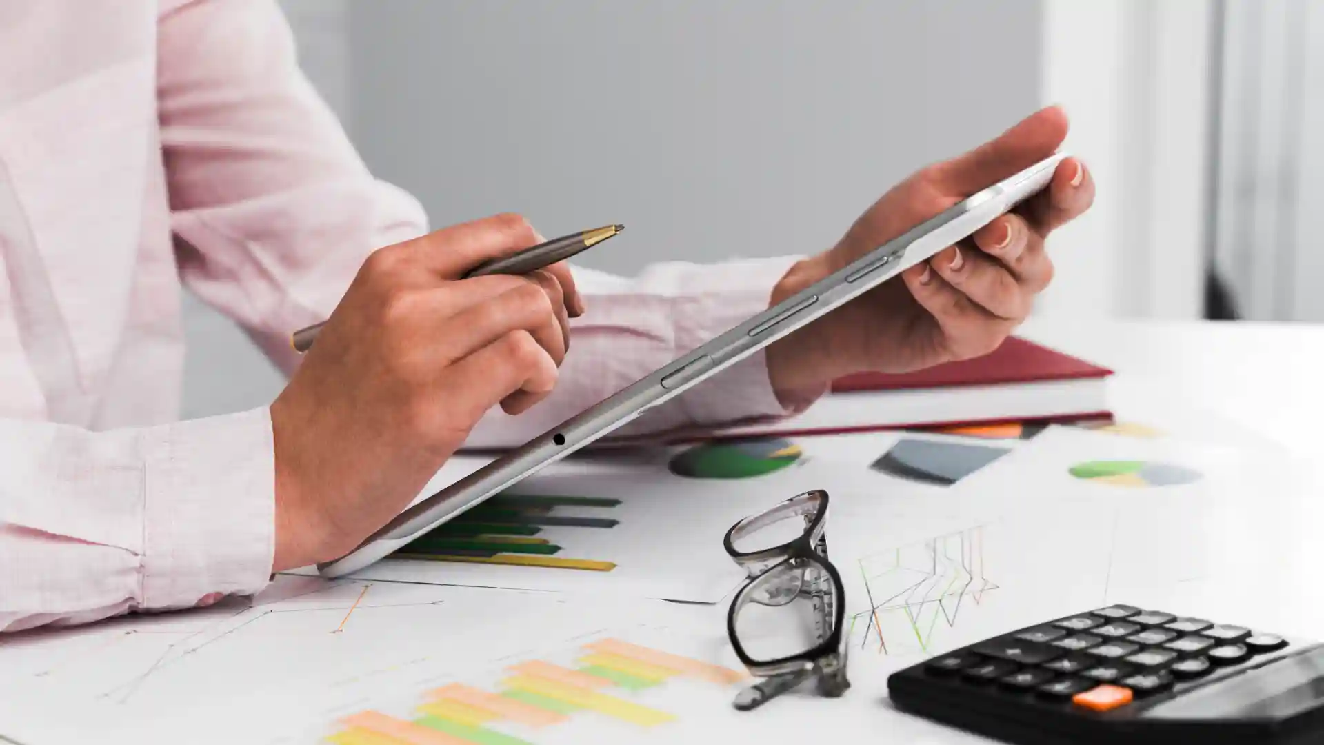 Employee analyzing labor data and reports on tablet – workforce planning and cost analysis