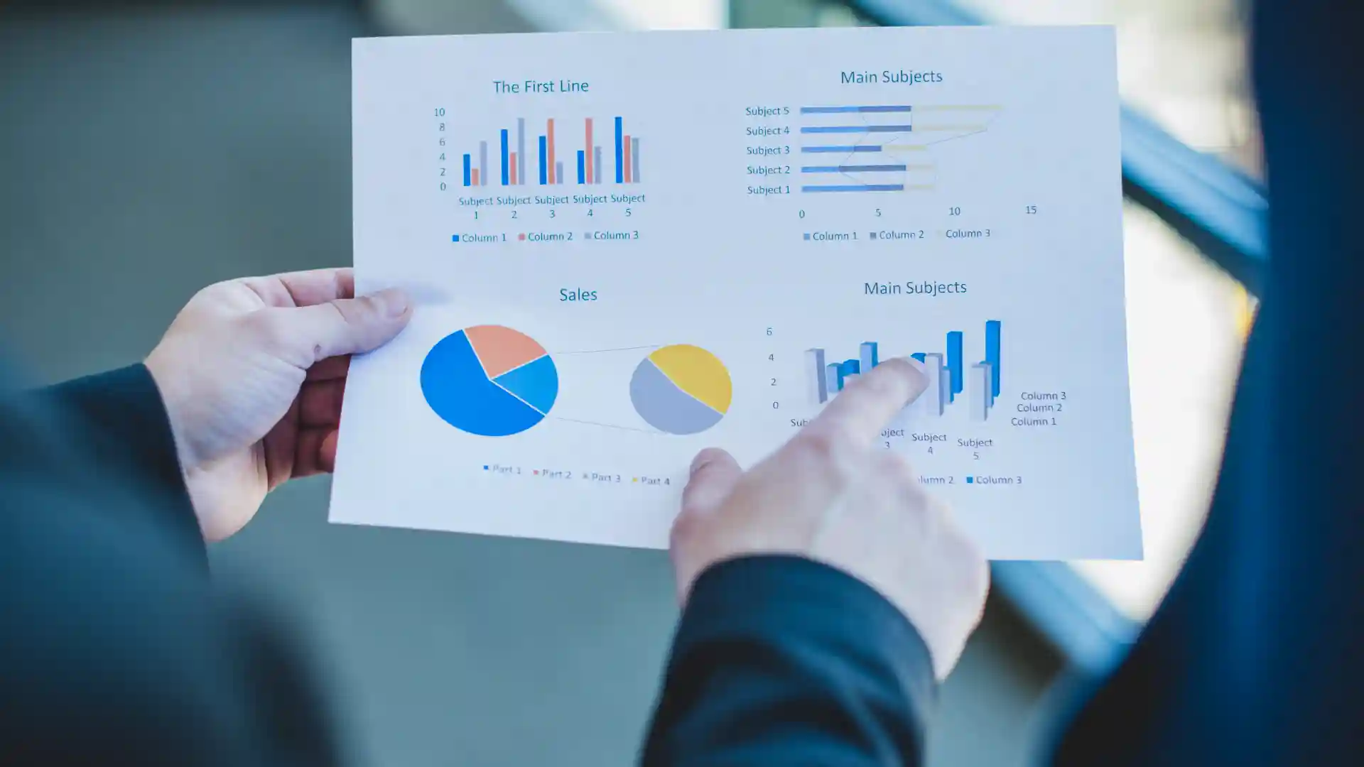 Reviewing printed analytics report with pie charts and bar graphs for operational performance
