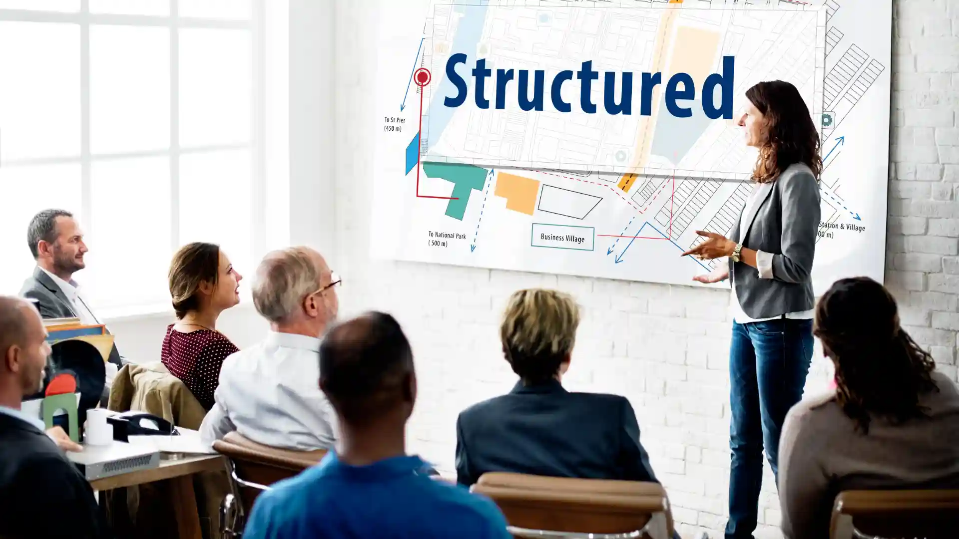 Instructor leading NAVIS training for port terminal staff using structured operations map